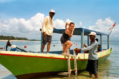 Vanessa climbing into a boat on our way to Tanjung Benoa.