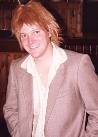 Dan in seventies outfit, with sad wig.